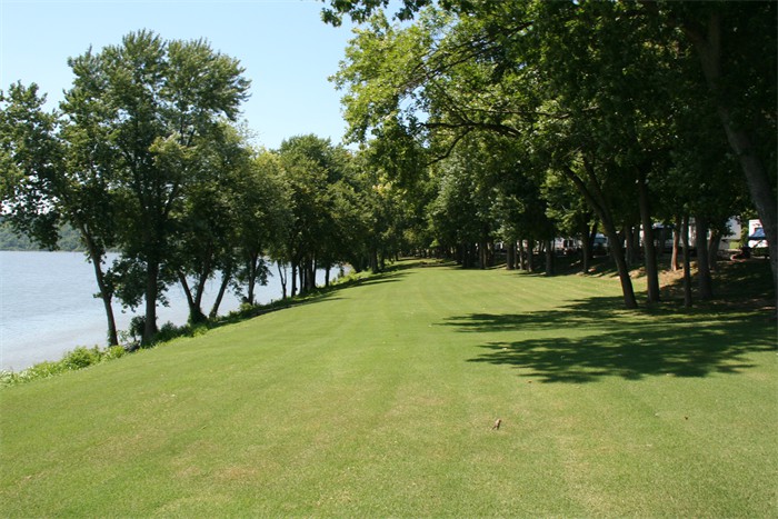 There is a large grassy area in front of our riverfront campsites.